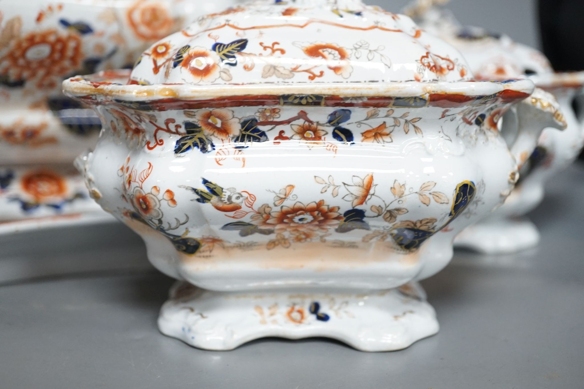 An early 19th century stoneware soup tureen and cover on stand, decorated in cobalt blue and iron red, a similar tureen, a pair of small covered dishes, Staffordshire spaniels, etc.